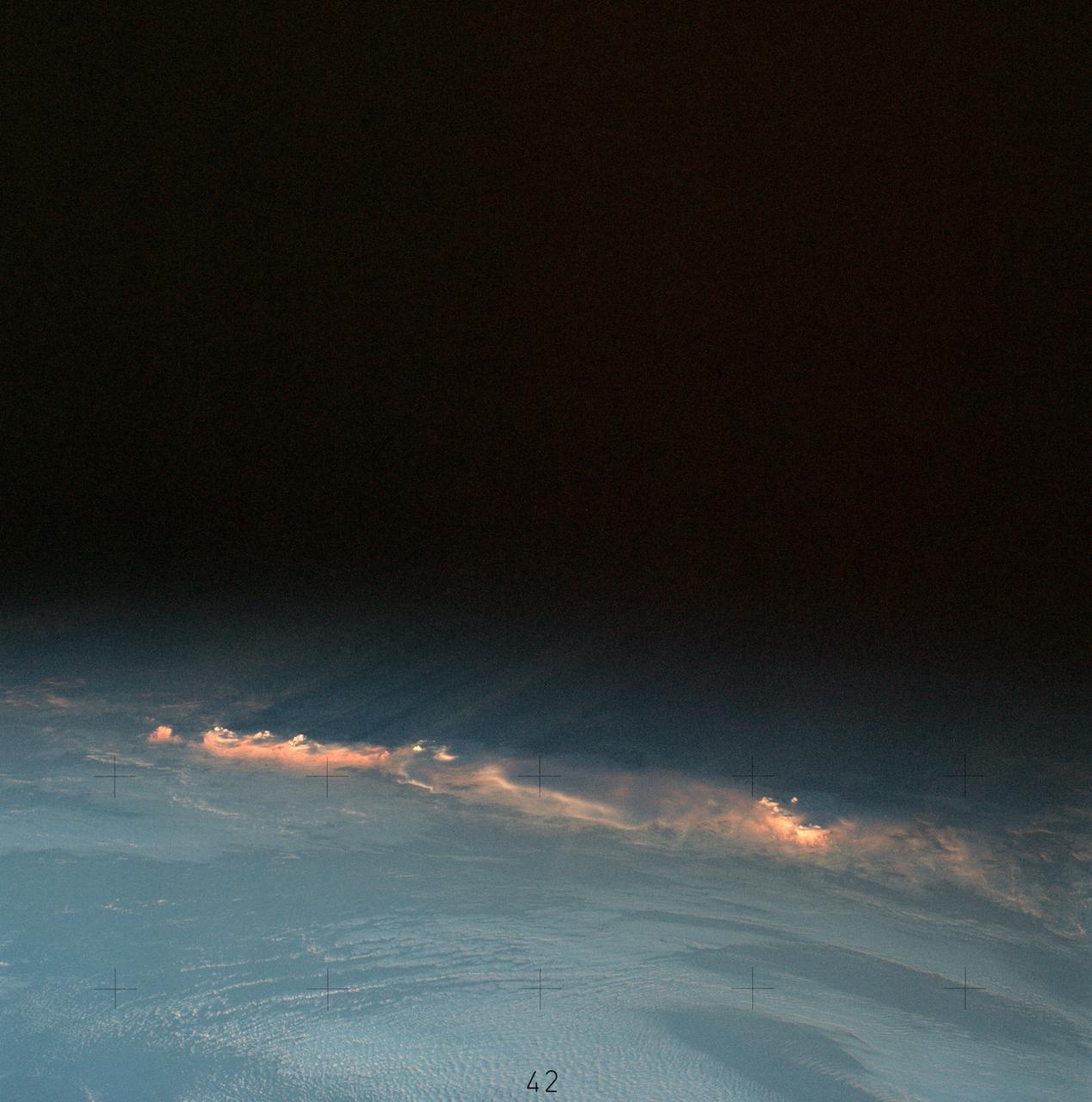 SL4-137-3566 (12 Dec. 1973) --- A group of clouds near New Zealand, as photographed from the Skylab space station in Earth orbit by one of the Skylab 4 crew members. The camera used was a hand-held 70mm Hasselblad with SO-368 medium speed Ektachrome. This picture shows vividly how low sun angles enhance relief, giving these clouds a three-dimensional appearance. In addition to being "pretty," this photograph can be used to study the line of storms seen here at sunset. Relative heights of individuals cells can be measured, as well as their relation to the surrounding clouds. Photo credit: NASA