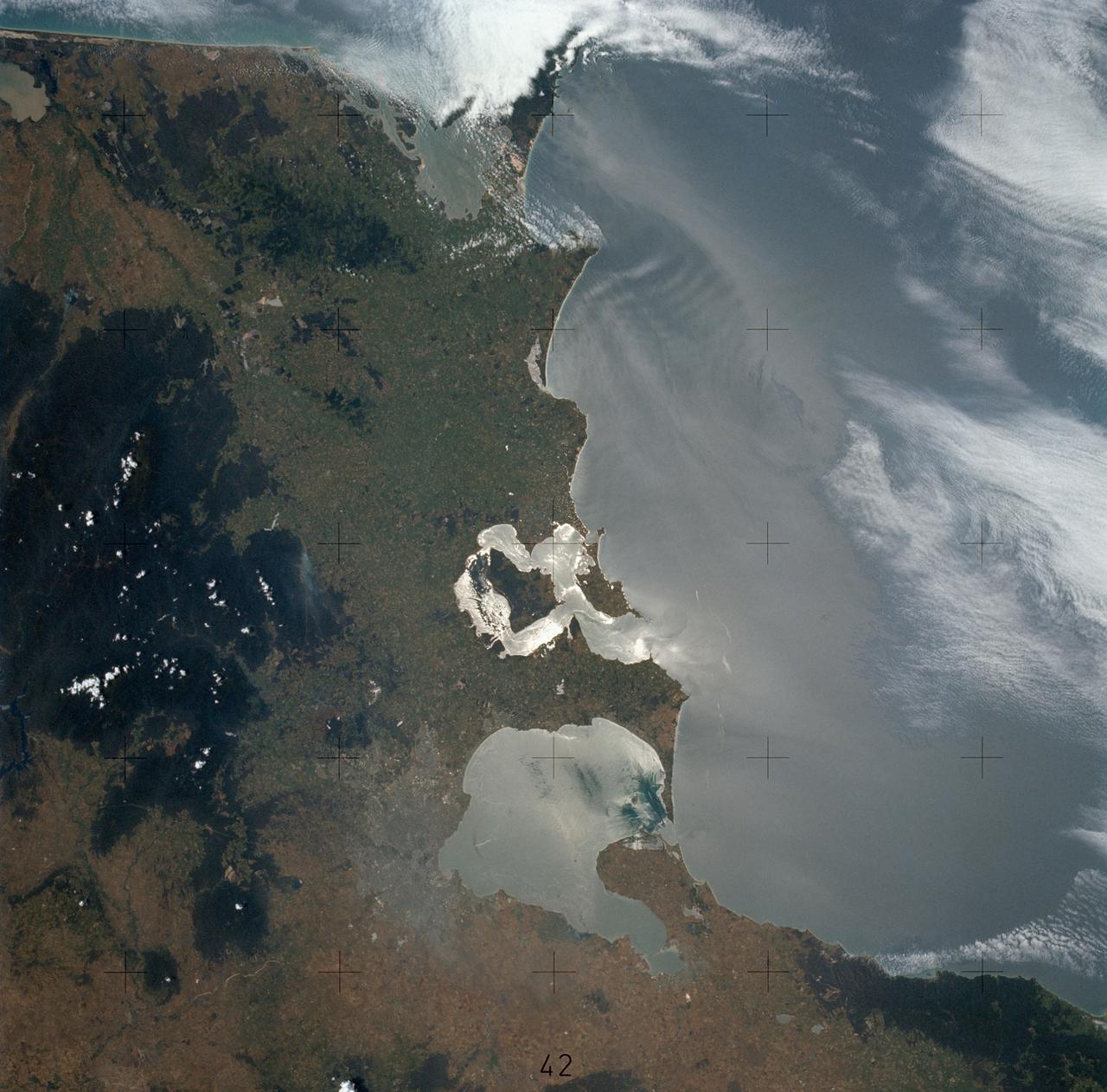 SL4-137-3578 (13 Dec. 1973) --- A near vertical view of the Melbourne, State of Victoria, Australia area as seen from the Skylab space station in Earth orbit. Note sunglint. This picture was taken by one of the Skylab 4 crewmen using a hand-held 70mm Hasselblad camera. Included in this view are Port Phillip Bay, Ninety-Mile Beach and the Australian Alps. In general, sunglint allows best viewing of ocean surface features.  Compare this view with that of SL4-137-3579 which is not in sunglint. Colors are not easy to distinguish in sunglint, but are without it. There are surface features visible in the first photograph which are not visible in the second. Similarly, some water colors are evident in the second photograph which are not seen in the first. Port Phillip is the best sample. The bay opens to the south. Photo credit: NASA