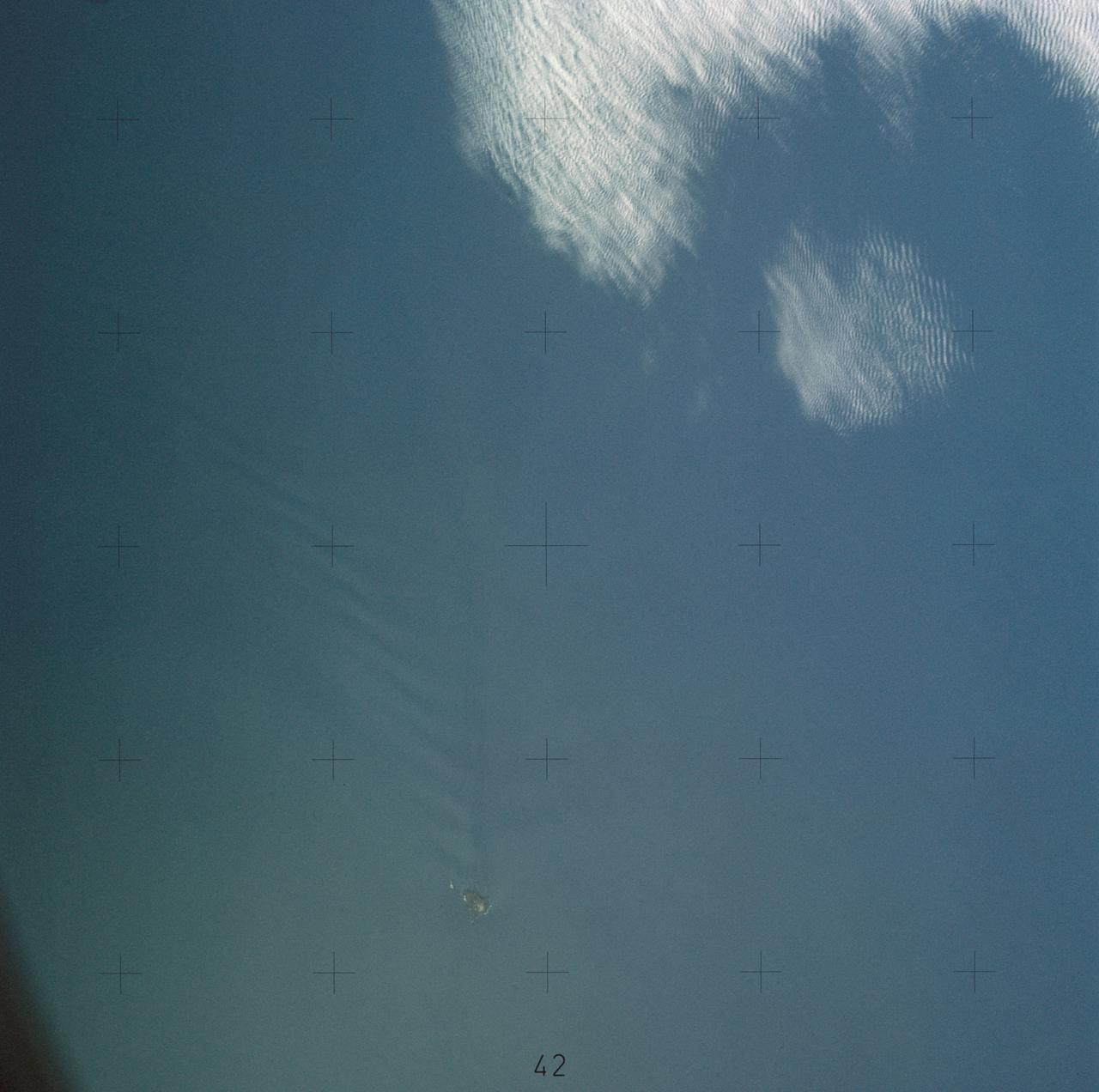 SL4-137-3655 (16 Dec. 1973) --- An island wake produced by the Antipodes Islands in the ocean current south of New Zealand is seen in this photograph taken from the Skylab space station in Earth orbit. A Skylab 4 crewmen took the picture with a hand-held 70mm Hasselblad camera. The bow wave pattern is quite evident and can be used to determine the current speed from the angle of the bow wave if the propagation speed of the surface wave is known. Also, evident is the darker band extending downstream from the island tens of miles. This is the actual wake of the island. The existence of water color differences from within to outside a turbulent island wake may indicate a temperature difference, with cooler water being stirred to the surface in the wake. This temperature difference could be used to drive a thermo-electric type generator to reduce small islands' dependence on imported oil for power generation. Photo credit: NASA