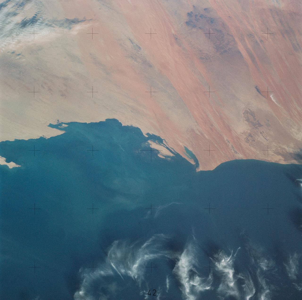 SL4-138-3756 (28 Dec. 1973) --- The northern half of Mauritania's Atlantic Coast, as photographed from the Skylab space station in Earth orbit by one of the Skylab 4 crewmen. The camera used was a hand-held 70mm Hasselblad, with SO-368 medium-speed Ektachrome. Spanish Sahara is just out of the picture to the north. The linear chains of sand dunes leading to the sea were the objects of study in an effort to better understand deserts and their formations. Photographs such as this were compared with similar ones taken over the drought-stricken areas including Mali and Niger in an attempt to understand the desertification processes which may be occurring there. Photo credit: NASA