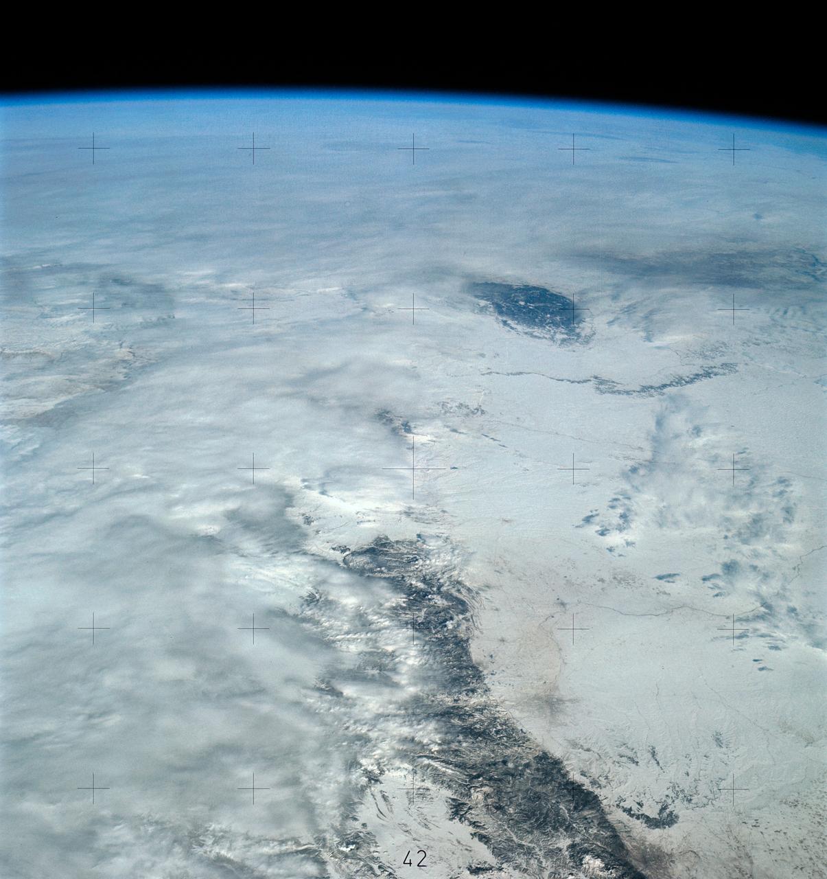 SL4-139-4040 (10 Jan. 1974) --- An oblique view of a portion of the Western United States, as photographed from the Skylab space station in Earth orbit by one of the Skylab 4 crewmen. The camera used was a hand-held 70mm Hasselblad, with SO-368 medium-speed Ektachrome film. This photograph is one of a stereo pair (the other being 4039) taken to support the hydrological studies of the changing snow patterns in several watersheds. Stereo analysis will enable snow to be distinguished from clouds quantitatively. In a qualitative sense, the clouds are the fuzzy white, whereas the snow is distinct white. The area covered is from the Colorado Springs, Colorado area at the south to (and beyond) the Black Hills, South Dakota area. The Black Forest between Colorado Springs and Denver is evident as are the mountains west of these cities. South Park, west of Colorado Springs, and the South Platte River running north and east from Denver are two other conspicuous features. Photo credit: NASA