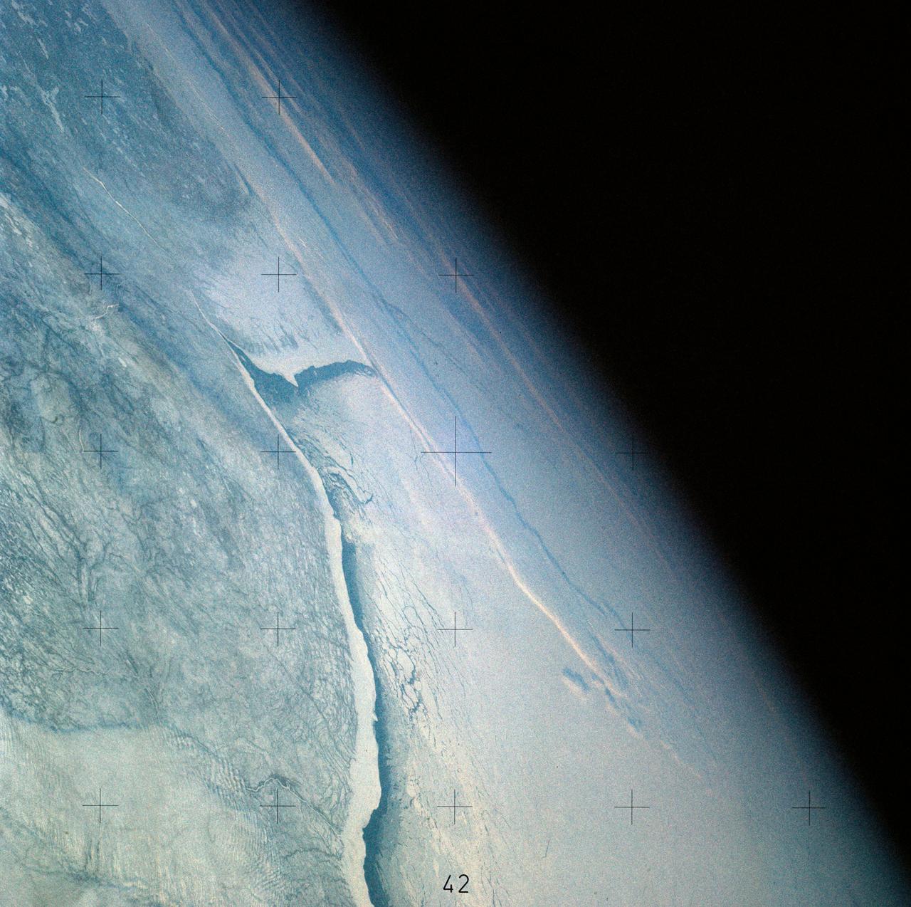 SL4-141-4316 (20 Jan. 1974) --- An oblique view of ice formations in Canada's Hudson Bay, as photographed from the Skylab space station in Earth orbit by one of the Skylab 4 crewmen. The camera used was a hand-held 70mm Hasselblad, with SO-368 medium-speed Ektachrome film. The southwestern part of the bay is prominent with the Nelson River in Manitoba flowing into it. Skylab never flew this far north in latitude. However, its orbital vantage point allowed observations and photography while over a point some 600 miles away as in the case of this picture. The ice formation along the southwest portion of Hudson Bay can be studied from photographs such as this one. The buildup of ice along the windward shore (very white) followed by the clear water gap (dark) caused by the wind blowing the newly formed ice toward the opposite shore, and finally the patterns in the ice structure itself are studied to learn more of the nature of the "winterization" of this area. Photo credit: NASA