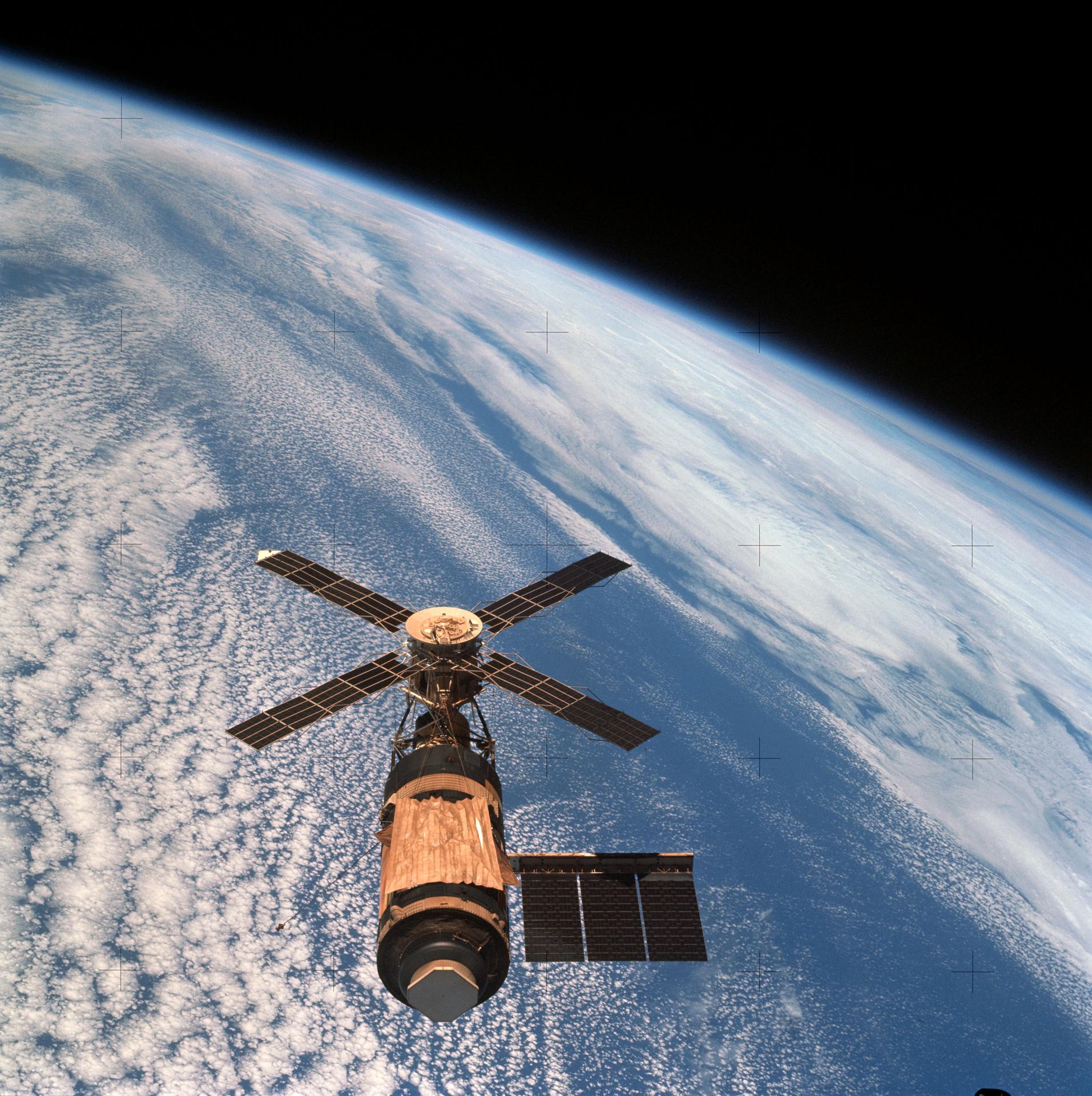 The Skylab space station is seen in orbit over the Earth by the Skylab 4 crew.