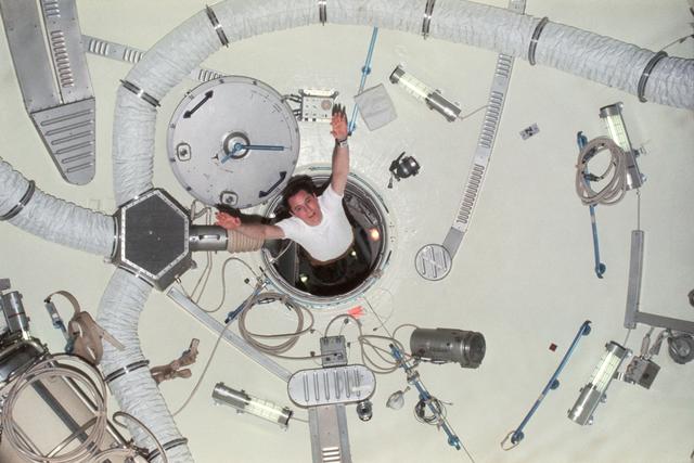 NASA image: Astronaut Edward Gibson sails through airlock module hatch