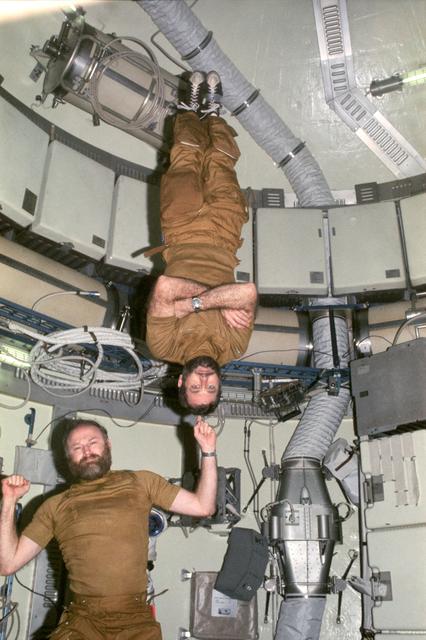 NASA image: Astronauts Carr and Pogue demonstrate weight training in zero-gravity