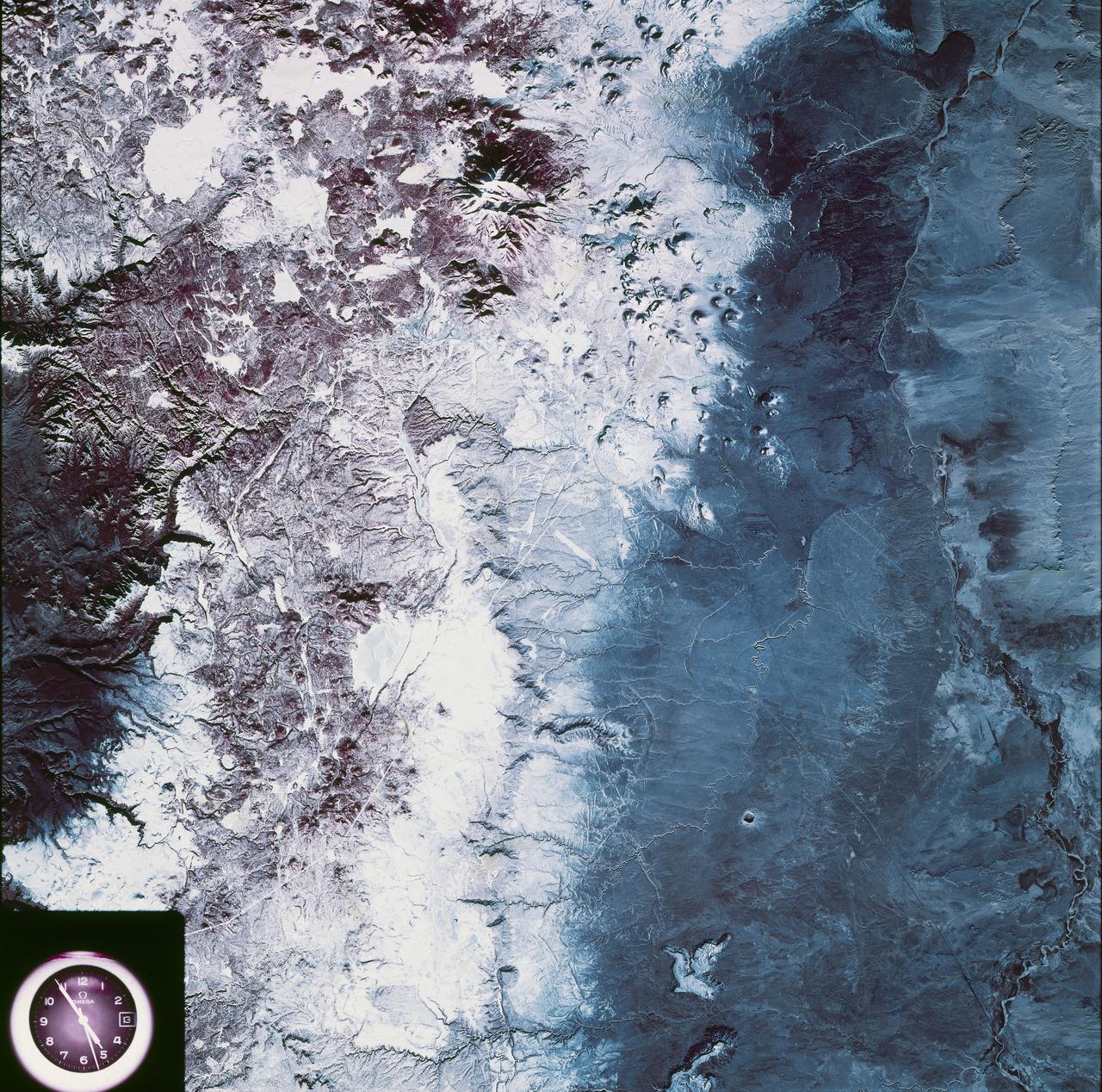 SL4-93-067 (16 Nov. 1973-8 Feb. 1974) --- A spectacular winter view of the Flagstaff, Arizona area is seen in this Skylab 4 Earth Resources Experiments package S190-B (five-inch earth terrain camera) infrared photograph taken from the Skylab space station in Earth orbit. Included in the scene are the San Francisco Mountains, Oak Creek Canyon, Painted Desert and Meteor Crater. The infrared picture depicts in red living vegetation, in white the snow, and in bright blue the water. Major features identified in this photograph are Humphrey's peak, top center, Flagstaff at foot of the peak, Sunset Crater volcanic field with numerous vents and craters right of Flagstaff and Meteor Crater (right center). Within the mountainous areas several clear areas generally rectangular are visible and represent the areas where lumbering has removed the forest. The thin white line extending from left corner to Sunset Crater fields is the power transmission line cleared area. Roads are subdued and are not easily visible. Photo credit: NASA