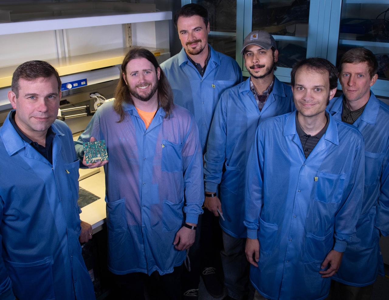 Several Goddard technologists are involved in a new CubeSat technology-demonstration mission called SNoOPI, which employs a novel remote-sensing technique for measuring soil-moisture levels. From left to right: Jeffrey Piepmeier, Chase Kielbasa, who is holding a first-generation prototype circuit board for the SNoOPI instrument, Joseph Knuble, Manuel Vega, Michael Coon, and Derek Hudson.