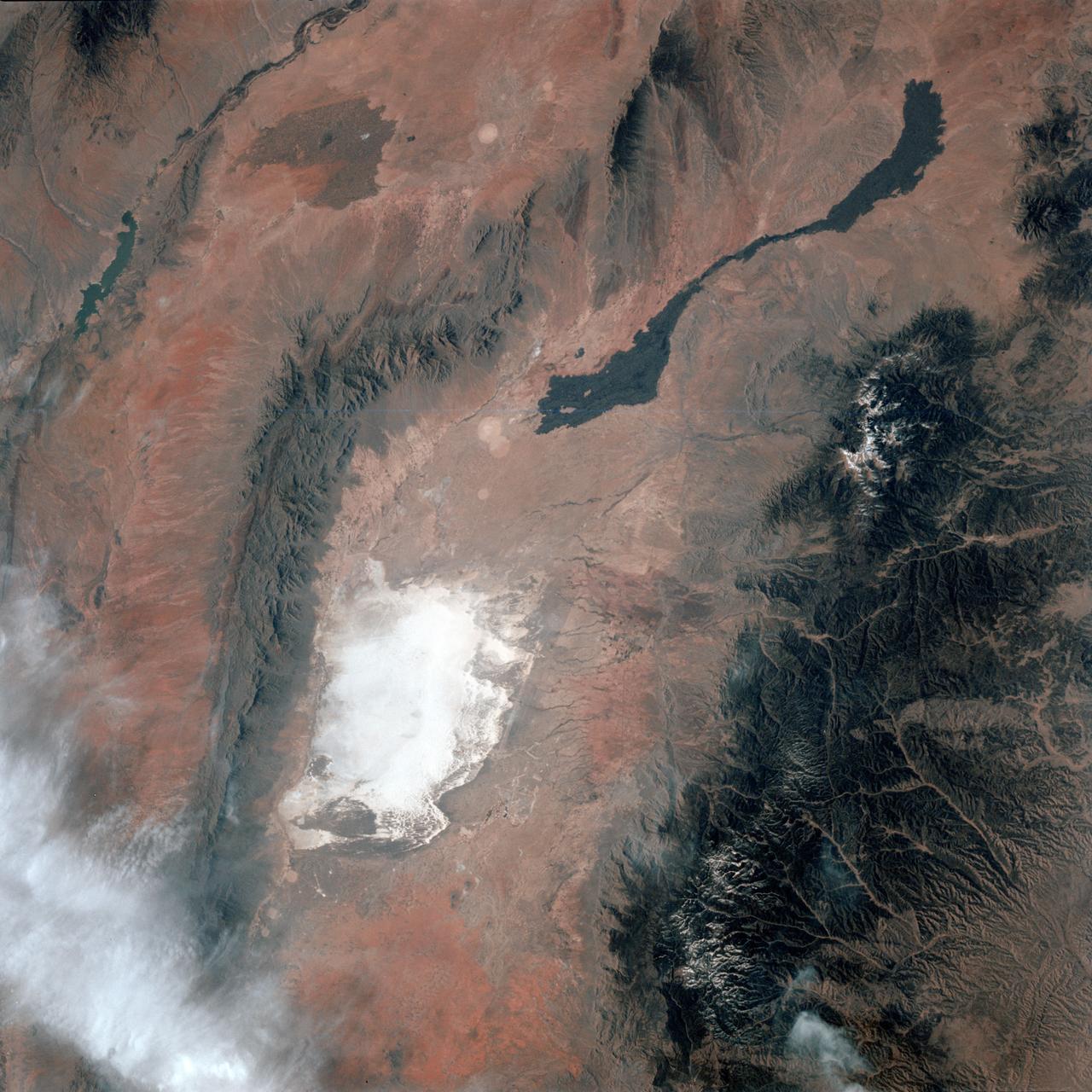 STS003-010-613 (22-30 March 1982) --- A truly remarkable view of White Sands and the nearby Carrizozo Lava Beds in southeast NM (33.5N, 106.5W). White Sands, site of the WW II atomic bomb development and testing facility and later post war nuclear weapons testing that can still be seen in the cleared circular patterns on the ground. Space shuttle Columbia (STS-3), this mission, landed at the White Sands alternate landing site because of bad weather at Edwards AFB, CA. Photo credit: NASA