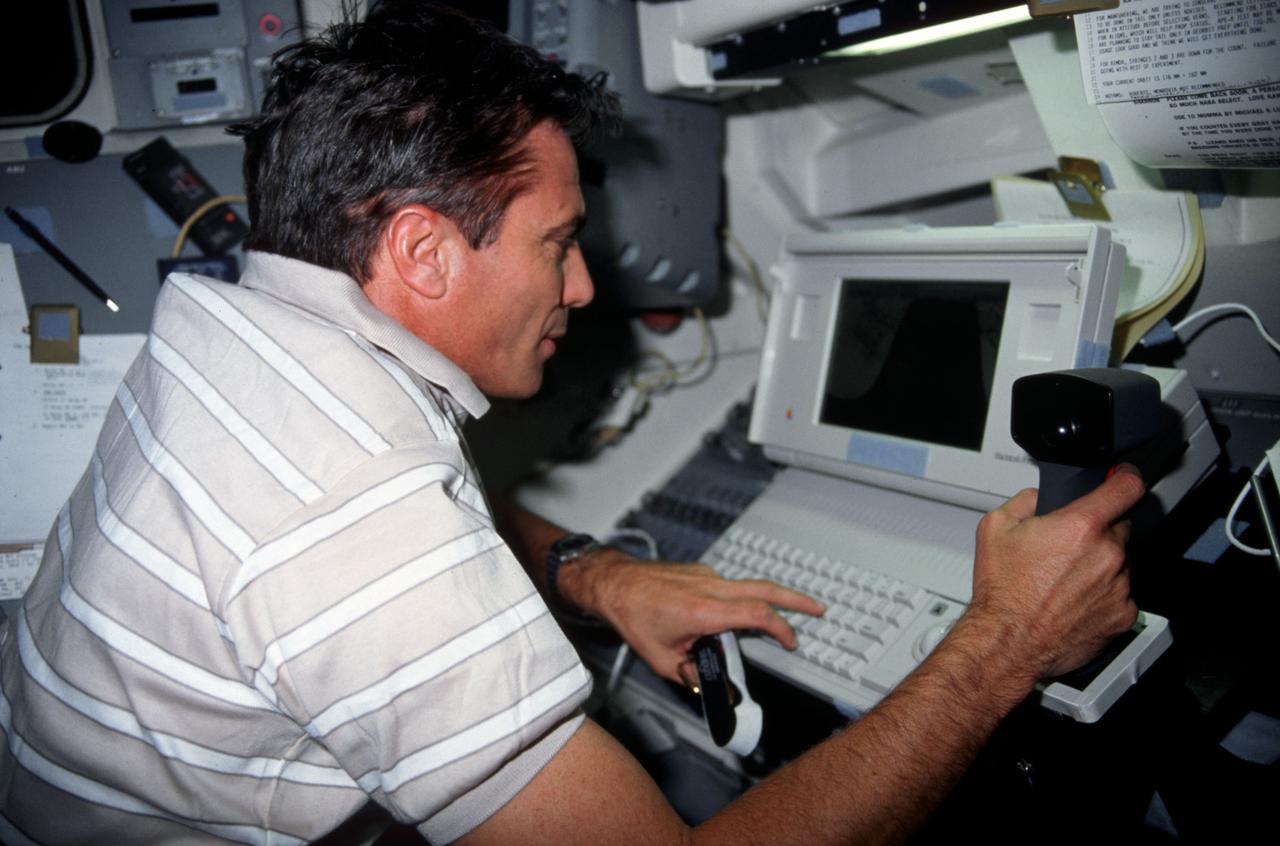 STS043-03-009 (5 Aug 1991) ---- Astronaut John E. Blaha is pictured executing development test objective  (DTO) 1208, Space Station Cursor Control Device Evaluation II and advanced applications.  The purpose of the Cursor Control Device Experiment is to evaluate human performance under space flight conditions of cursor control devices which are similar to the devices under consideration for use onboard Space Station computers.  Here, the mission commander uses a thumbball/handgrip control device.  Each crewmember evaluated the different types of cursor control devices during the nine-day STS-43 mission.  Other methods of cursor control evaluated were the built-in trackball, a side mounted trackball with restraints and an optical pad with mouse.