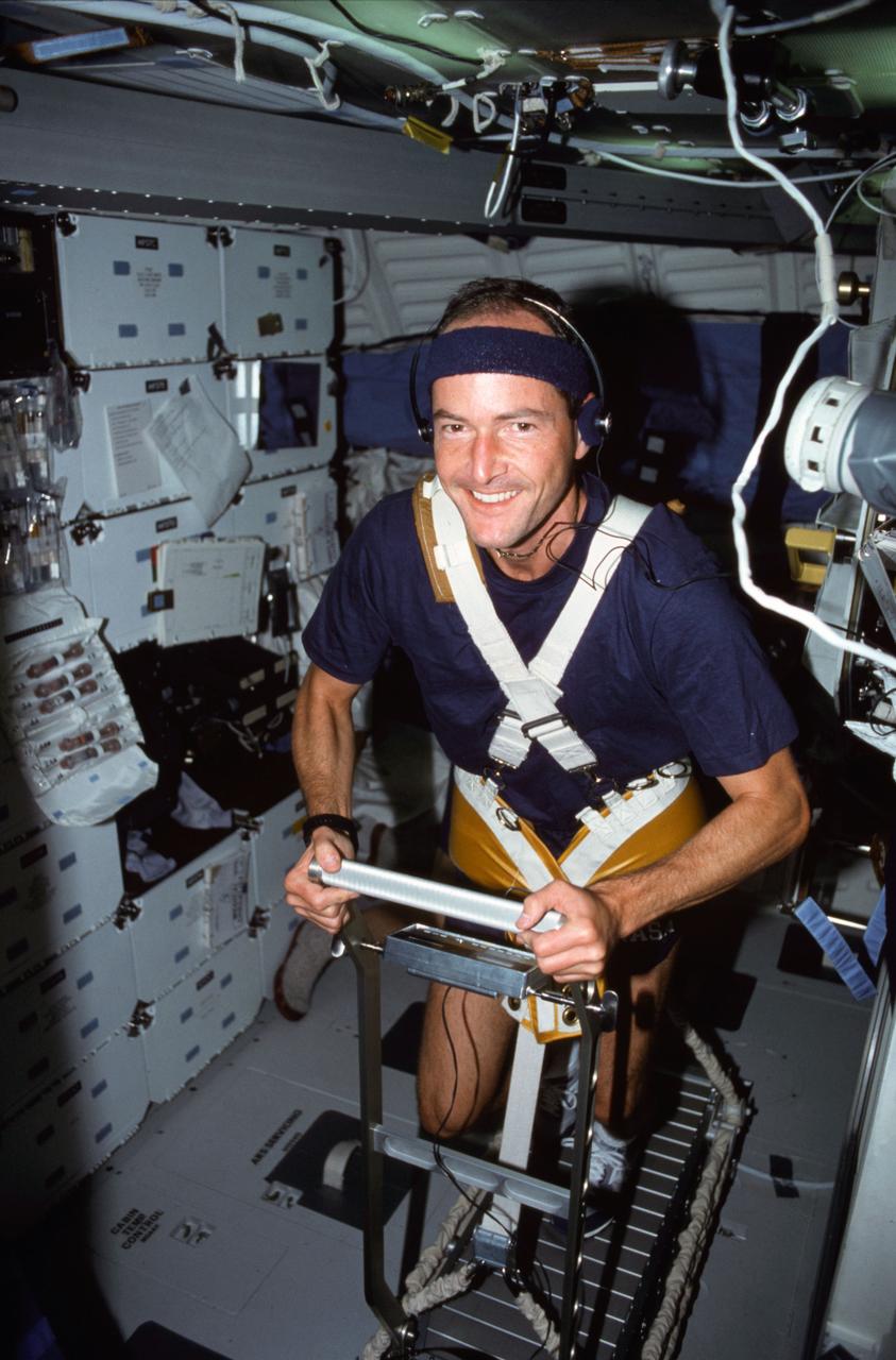 STS043-04-016 (2-11 Aug 1991) --- Astronaut G. David Low, STS-43 mission specialist, works out on a treadmill device which was used for medical testing on the nine-day flight.  The scene, photographed with a 35mm camera, is on Atlantis? flight deck.