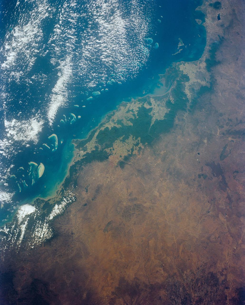 Cairns and Townsville area, on the northeast coast of Queensland, Australia (17.0S, 146.0E) is one of the best sport diving localities in the world where divers can explore the rich and varied flora and fauna of the nearby Great Barrier Reef. Onshore, the timbered foothills of the Great Dividing Range, seen as dark green areas, separate the semi arid interior of Queensland.