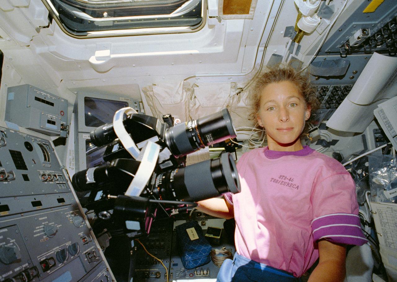 STS046-03-032 (31 July-8 Aug 1992) --- Astronaut Marsha S. Ivins, mission specialist, prepares to operate a tandem of 70mm Hasselblad cameras on the Space Shuttle Atlantis' aft flight deck. The cameras share a common mount, allowing for various tests to be run as the cameras record the same Earth-observations type imagery. Ivins was joined by four other NASA astronauts and two Europeans for an eight-day stay in Earth-orbit.
