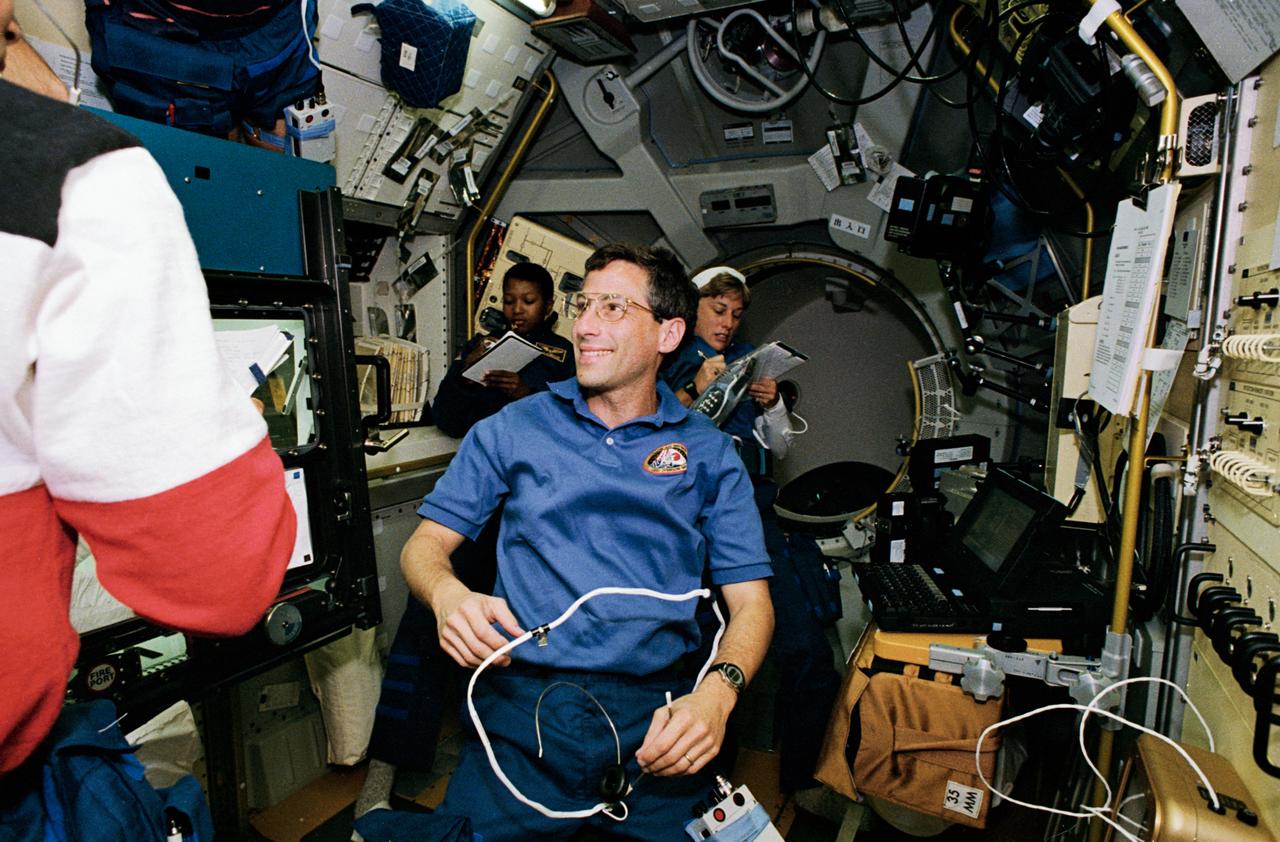 STS047-05-019 (12 - 20 Sept 1992) --- Astronaut Jerome (Jay) Apt, mission specialist, responds to a crew mate's query during a shift change in the Spacelab-J Science Module aboard the Earth-orbiting Space Shuttle Endeavour.  Others pictured, left to right, are astronauts Mark C. Lee (immediate foreground, partially out of frame), payload commander; Mae C. Jemison and N. Jan Davis, mission specialists.  The four joined two other NASA astronauts and a Japanese payload specialist for eight days aboard Endeavour in support of the joint Japanese-American effort.