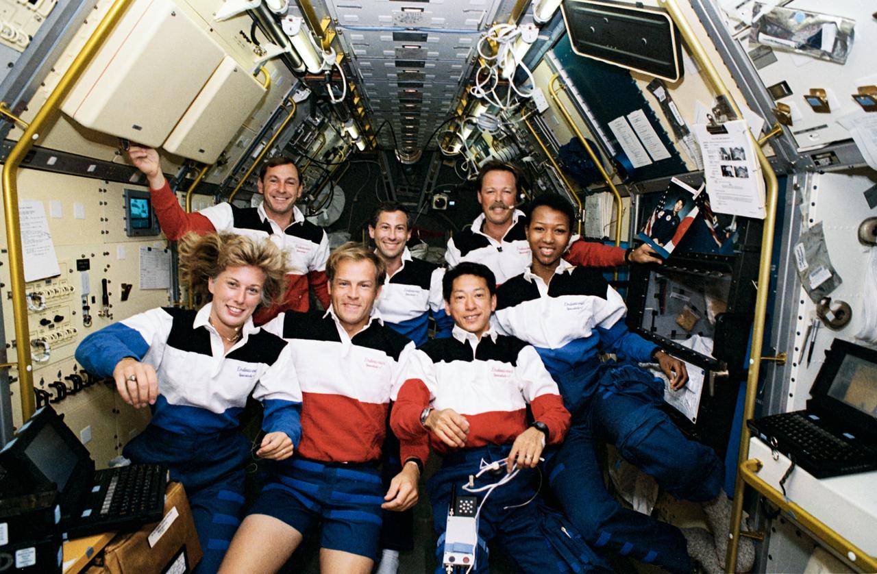 STS047-12-002 (12 - 20 Sept 1992)  --- The crew members assemble for their traditional in-flight portrait in this 35mm frame photographed in the Science Module aboard the Earth-orbiting Space Shuttle Endeavour.  Left to right (front) are N. Jan Davis, Mark C. Lee and Mamoru Mohri; and (rear) Curtis L. Brown, Jr., Jerome (Jay) Apt, Robert L. Gibson and Mae C. Jemison.  The seven spent eight days in space in support of the Spacelab-J mission.