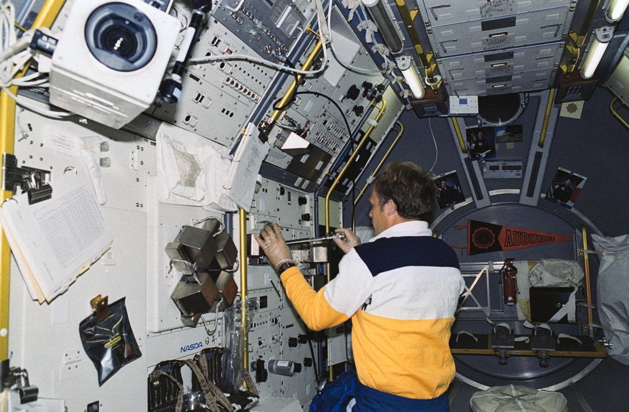 STS047-203-009 (12-20 Sept 1992) --- Astronaut Mark C. Lee, payload commander, inserts a sample into the Gradient Heating Furnace (GHF) in the Spacelab-J Science Module aboard the Earth-orbiting Space Shuttle Endeavour.  Lee, along with five other NASA astronauts and a Japanese payload specialist, conducted eight days of research in support of Spacelab-J.
