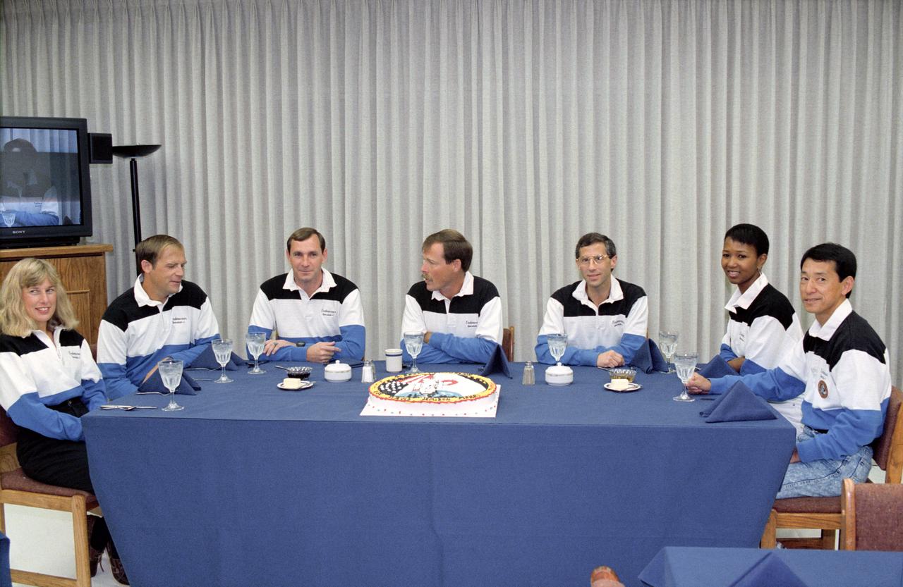 STS047-S-037 (12 Sept 1992) --- The seven crewmembers who will be aboard for Endeavour's second trip into space are about to have a light breakfast prior to the pre-launch suiting up process in the Operations and Checkout Building.  Left to right are astronauts N. Jan Davis, Mark C. Lee, Curtis L. Brown Jr., Robert L. Gibson, Jerome (Jay) Apt and Mae C. Jemison; and payload specialist Mamoru Mohri, representing the National Space Development Agency (NASDA) of Japan. This mission will be devoted to support of the Spacelab-J mission, a joint effort between Japan and the United States.  Launch occurred at 10:23:00:0680 a.m. (EDT), September 12, 1992.