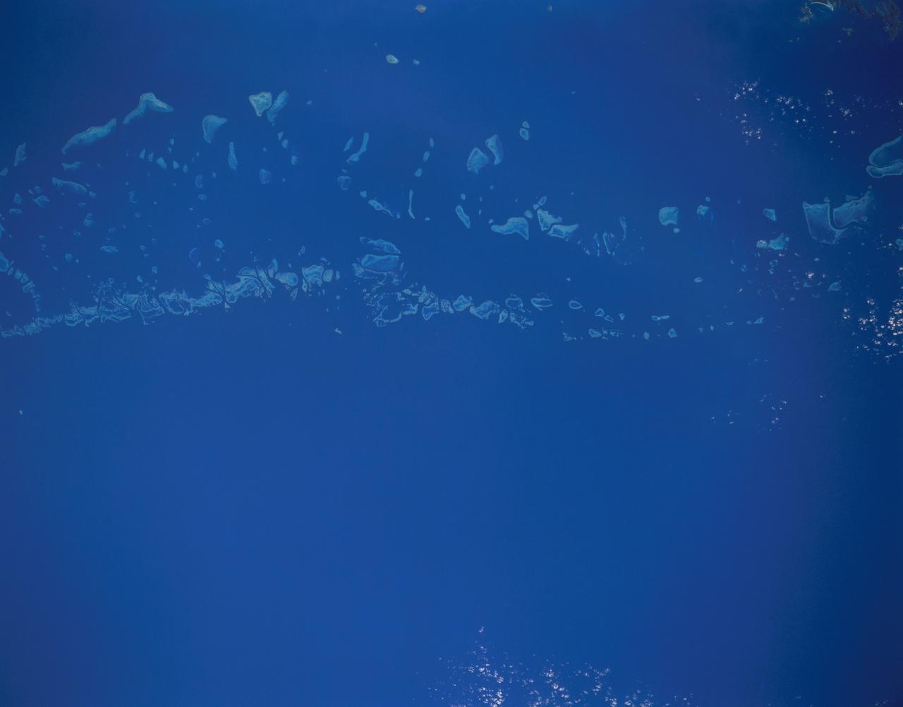 STS048-151-250 (12-18 Sept. 1991) --- The Great Barrier Reef extends for roughly 2,000 kilometers along the northeast coast of Australia. The great Barrier Reef is made up of thousands of individual reefs which define the edge of the continental shelf. The southern part of the feature, called Swain Reef, is seen here. Water depths around the reefs are quite shallow (less than 1 meter to about 36 meters in depth), but only a few kilometers offshore, water depths are roughly 1,000 meters.