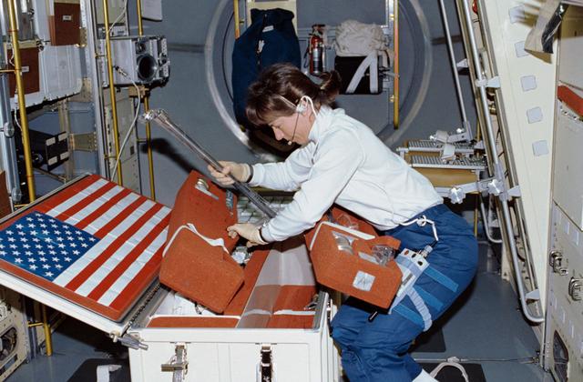 NASA image: Crewmember working on the spacelab Drop Physics Module, Rack 9.