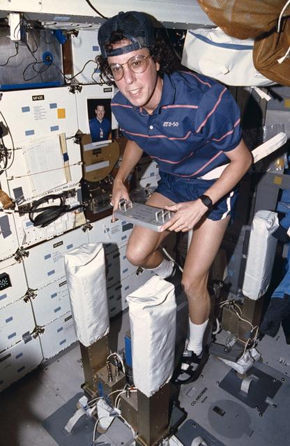 Crewmember exercising on the mid deck ergometer.