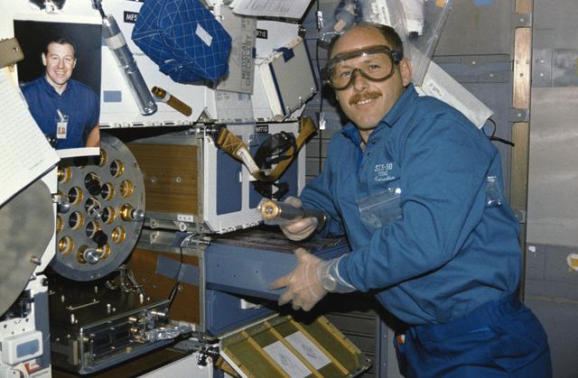 NASA image: Crewmember in the mid deck with the Zeolite Crystal Growth experiment.