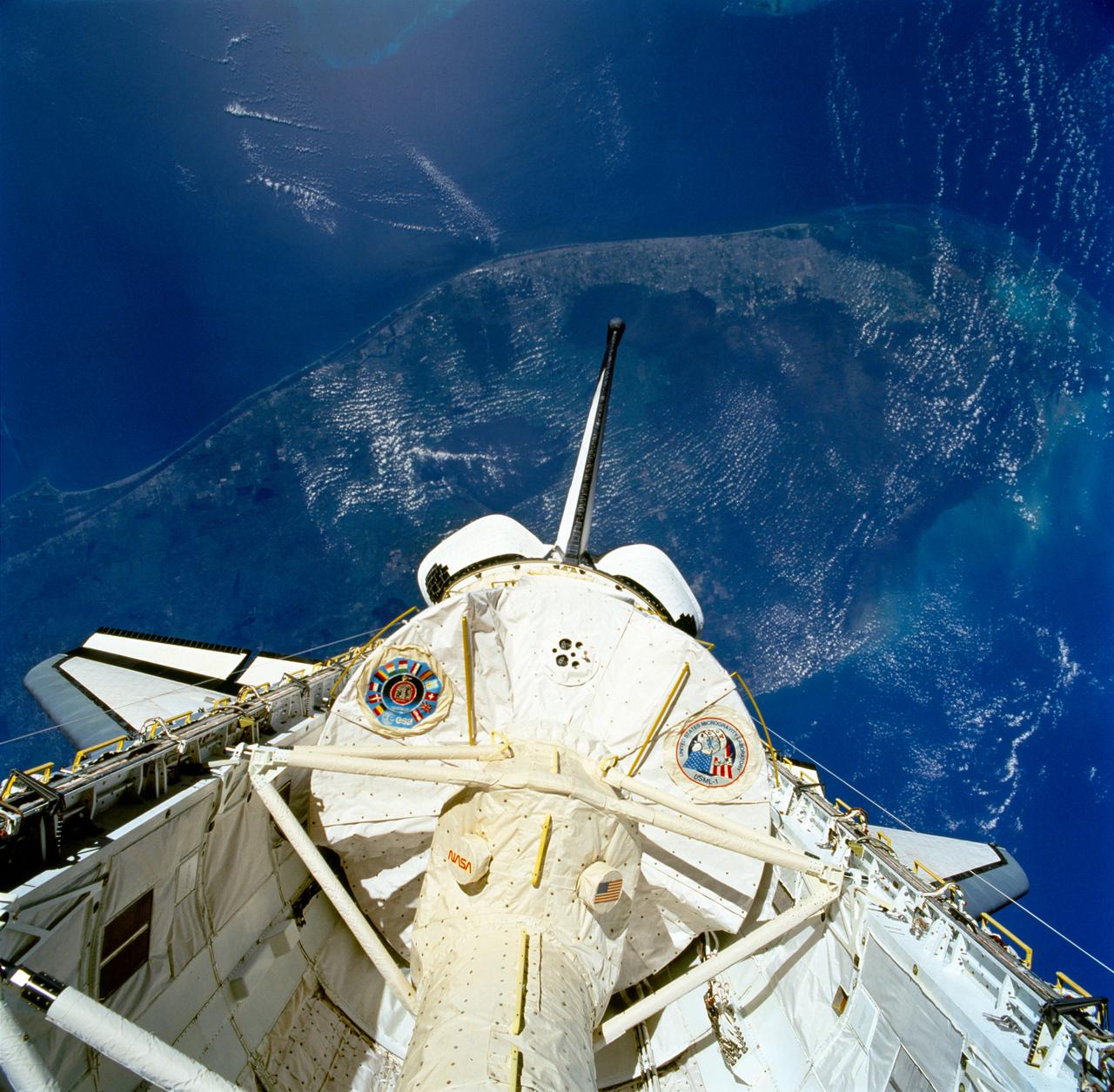 STS050-81-027 (25 June-9 July 1992) --- The first United States Microgravity Laboratory 1 (USML-1) module is pictured in the payload bay of the Earth-orbiting Space Shuttle Columbia in this scene over the southern two-thirds of the Florida peninsula. The Kennedy Space Center (KSC), where the mission began, can be seen just above Columbia's starboard wing. (Hold photo with number at left.)