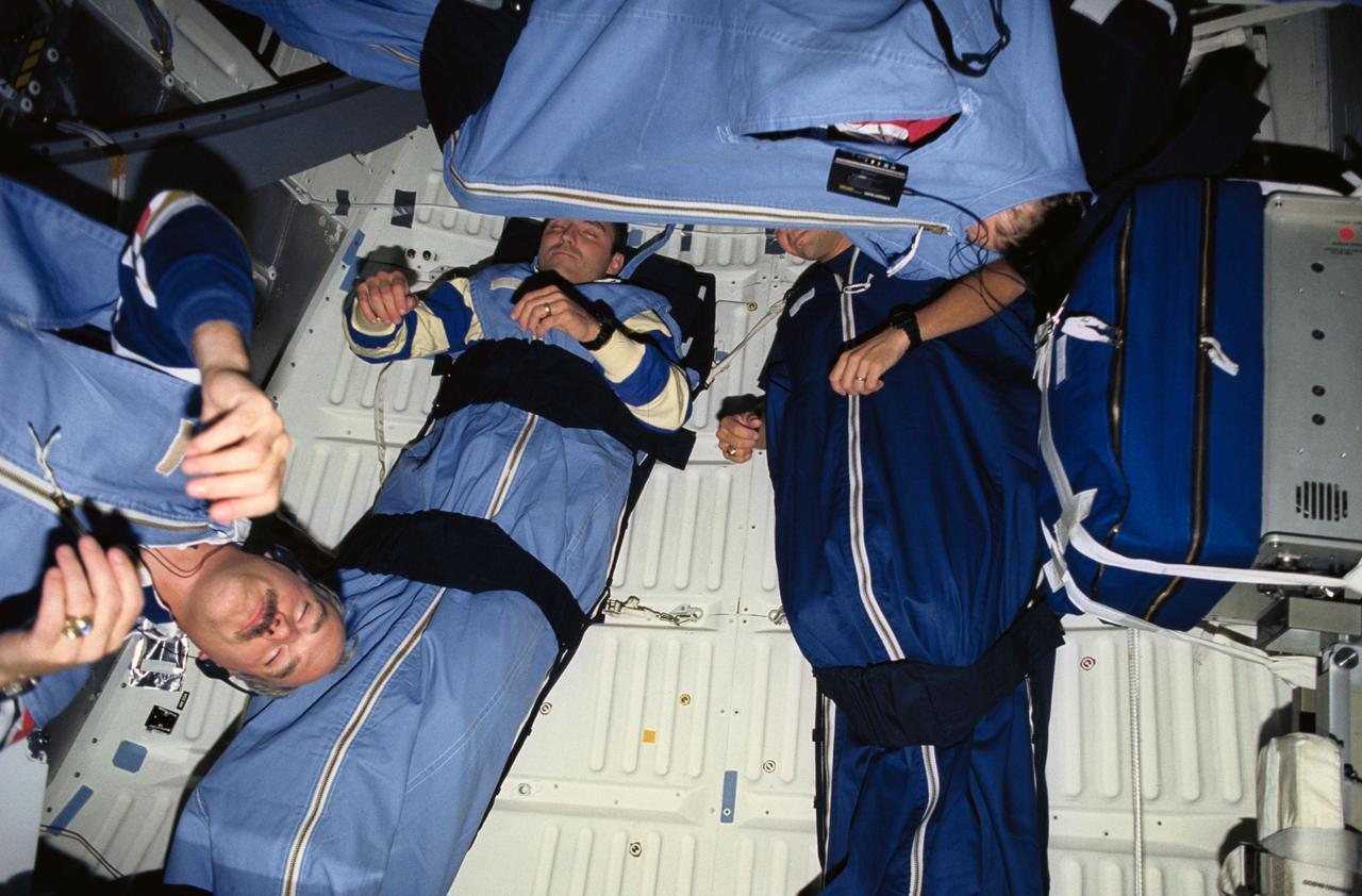 STS051-20-037 (12-22 Sept 1993) --- Four of the five astronaut crew members were photographed during one of their sleep periods on the Space Shuttle Discovery's mid-deck.  At bottom center, astronaut Frank L. Culbertson, Jr., mission commander, is barely visible, with most of his body zipped securely in the sleep restraint.  Others, left to right, are astronauts Daniel W. Bursch and Carl E. Walz, mission specialists, and William F. Readdy, pilot.  The photograph was taken by astronaut James H. Newman, mission specialist.