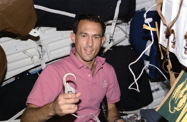 NASA image: Astronaut James Newman with latch hook for tether device