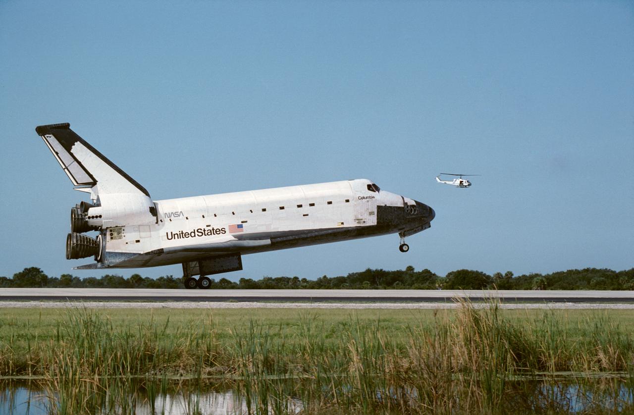 STS052-S-098 (1 Nov 1992) ---  This ground-level side view shows the Space Shuttle Columbia just prior to main landing gear touchdown at KSC's Shuttle Landing Facility to successfully complete a ten-day Earth-orbital mission.  Onboard were a crew of five NASA astronauts and a Canadian payload specialist. Landing occurred at 9:05:53 a.m. (EST), November 1, 1992.  Crewmembers are astronauts James D. Wetherbee, Michael A. Baker, Tamara E.  Jernigan, Charles L. (Lacy) Veach and William M. Shepherd along with payload specialist Steven G. MacLean.  The view was recorded with a 35mm camera.
