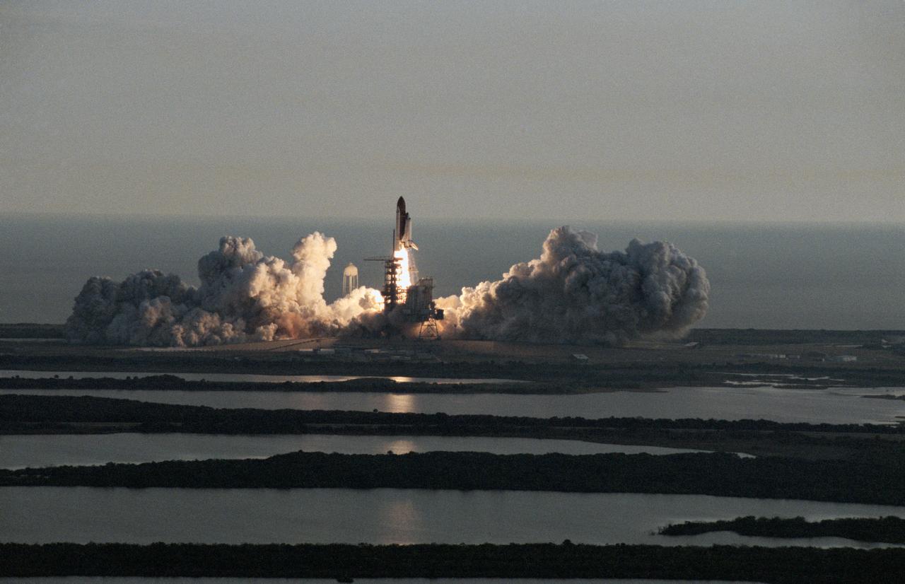 STS053-S-054 (2 Dec 1992) --- The Space Shuttle Discovery, with a crew of five astronauts onboard, launches from Kennedy Space Center?s (KSC) Pad 39A at 8:24:00 a.m. (EST), December 2, 1992.  The photograph was taken from the top of the giant Vehicle Assembly Building (VAB).  The all-military crew supporting the Department of Defense (DOD) flight included astronauts David M. Walker, Robert D. Cabana, Guion S. Bluford, Jr., James S. Voss and Michael R. U. (Rick) Clifford.