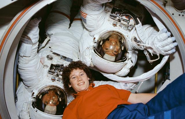 EVA Crewmembers emerging from the air lock into the middeck.