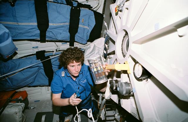 NASA image: Crewmember in the middeck with Commercial Generic Bioprocessing experiment.