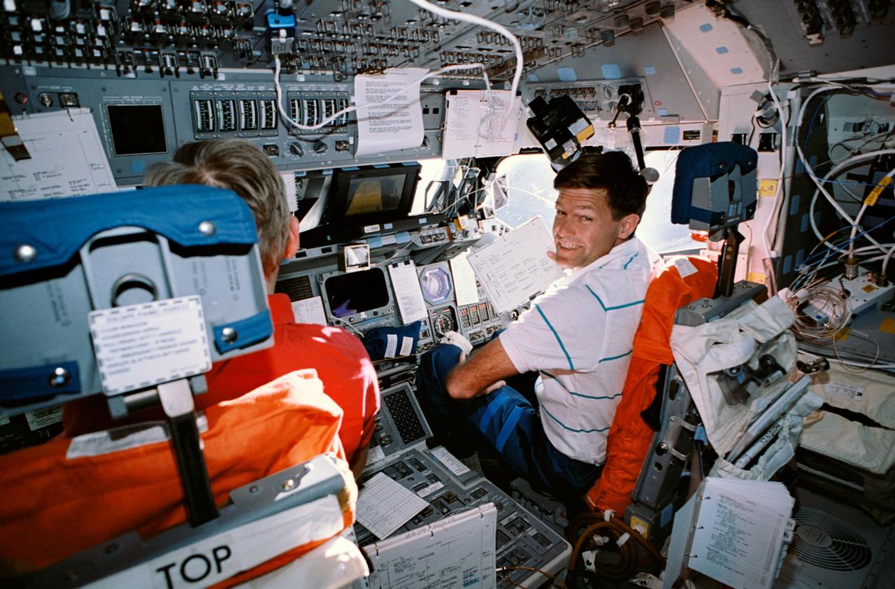 STS054-30-022 (13-19 Jan 1993) --- Astronaut Donald R. McMonagle (right), pilot, shares the forward flight deck with astronaut John H. Casper, mission commander, as the pair performs a maneuver of the Shuttle Endeavour in Earth orbit.  The photograph was taken with a 35mm camera.