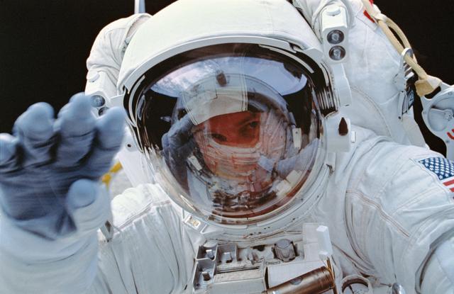 NASA image: EVA-1 Crewmember Greg Harbaugh (red stripe) working in payload bay.