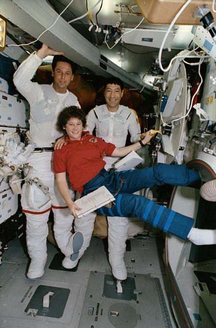 NASA image: Mission Specialists Mario Runco and Greg Harbaugh suiting up for EVA.