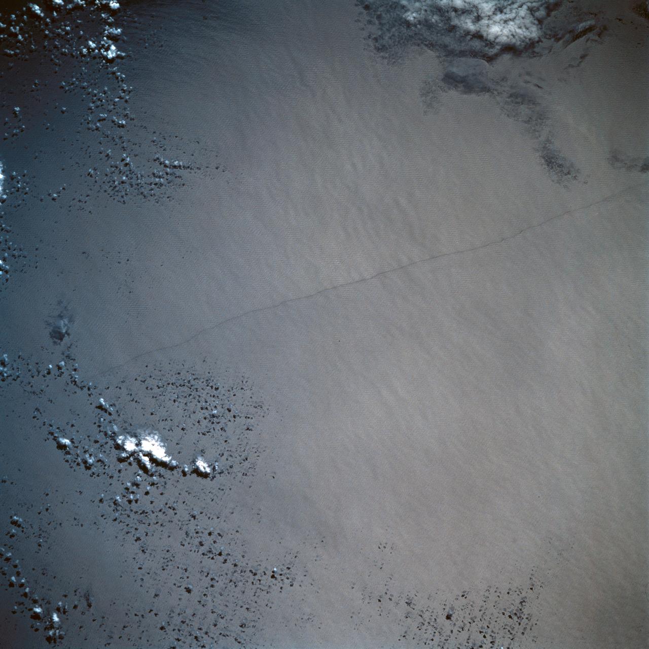 STS054-95-042 (13-19 Jan 1993) --- The Equatorial Pacific Ocean is represented in this 70mm view. The international oceanographic research community is presently conducting a program called Joint Global Ocean Flux Study (JGOFS) to study the global ocean carbon budget. A considerable amount of effort within this program is presently being focused on the Equatorial Pacific Ocean because of the high annual average biological productivity. The high productivity is the result of nearly constant easterly winds causing cool, nutrient-rich water to well up at the equator. In this view of the sun glint pattern was photographed at about 2 degrees north latitude, 103 degrees west longitude, as the Space Shuttle passed over the Equatorial Pacific. The long narrow line is the equatorial front, which defines the boundary between warm surface equatorial water and cool, recently upwelled water. Such features are of interest to the JGOFS researchers and it is anticipated that photographs such as this will benefit the JGOFS program.