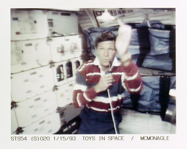 NASA image: STS-54 Pilot McMonagle with DSO 802 & Physics of Toys top on OV-105's middeck