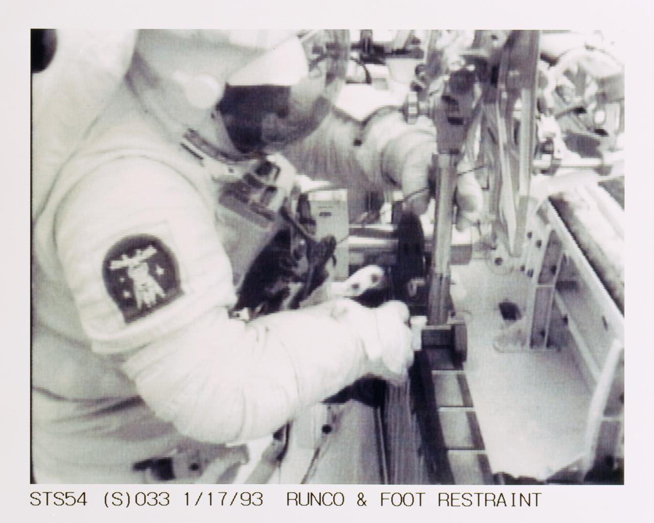 STS054-S-033 (17 Jan 1993) --- Runco works with a mobile foot restraint during extravehicular activity (EVA) in Endeavour's cargo bay.  The scene was downlinked at 11:52:04:28 GMT, Jan. 17, 1993.
