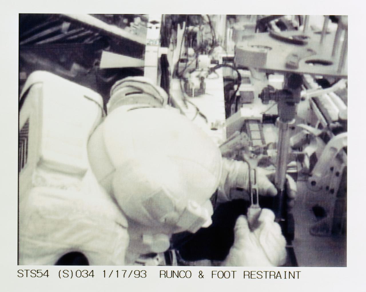 STS054-S-034 (17 Jan 1993) --- Closeup view of Runco as he works to install a mobile foot restraint during extravehicular activity (EVA) in Endeavour's cargo bay.  The scene was downlinked at 11:55:07:24 GMT, Jan. 17, 1993.
