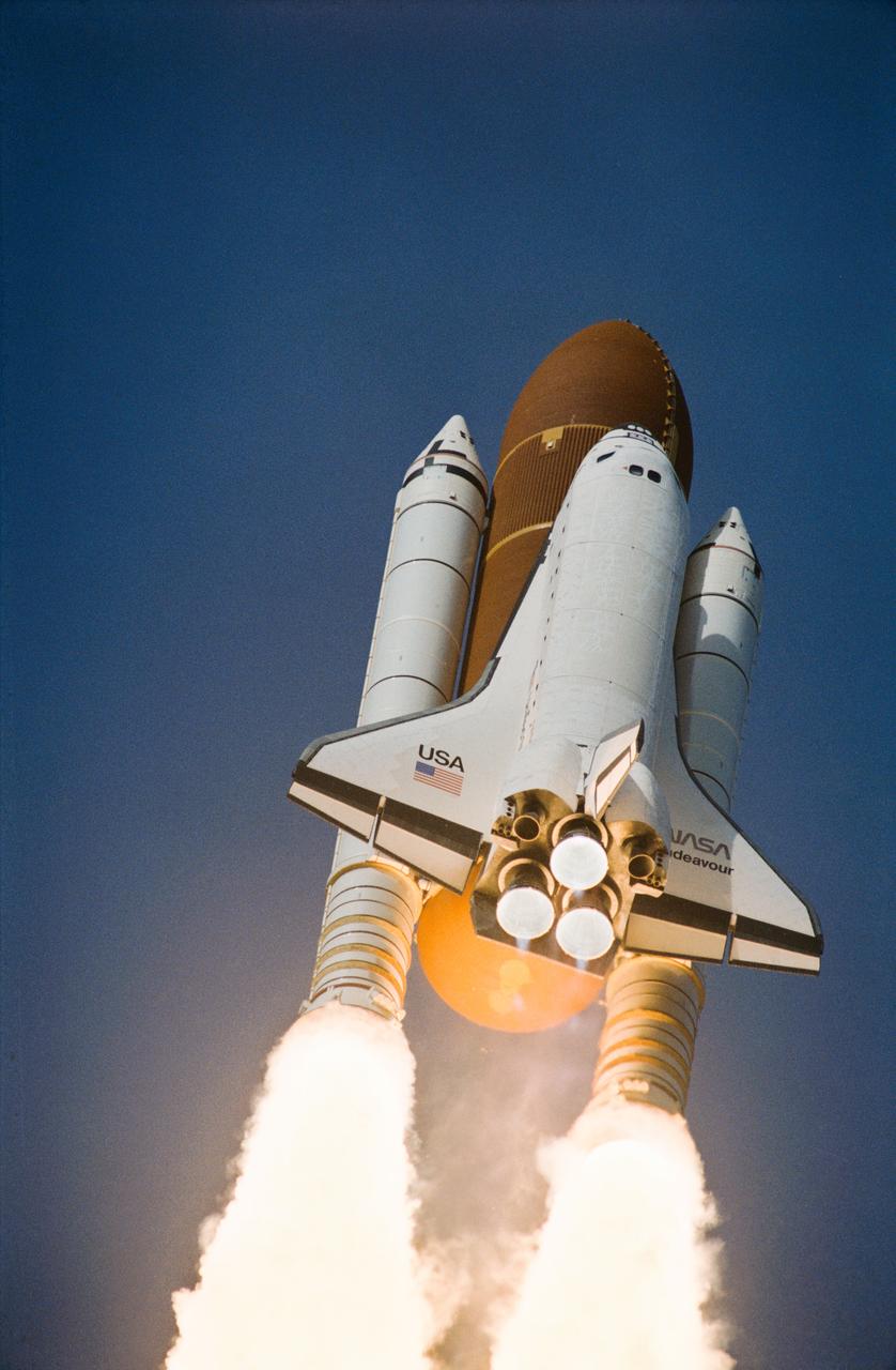 STS054-S-062 (13 Jan 1993) --- A low-angle view of the Space Shuttle Endeavour as it soars off the launch pad and heads toward Earth orbit with a crew of five and the Tracking and Data Relay Satellite (TDRS-F) aboard. Launch occurred at 8:59:30 a.m. (EST), January 13, 1993. Onboard were John H. Casper, mission commander, Donald R. McMonagle, pilot, Gregory J. Harbaugh, Mario Runco Jr., and Susan J. Helms, mission specialists.