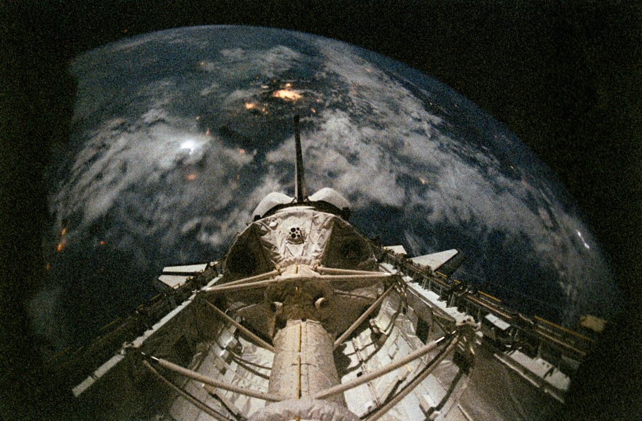 STS055-26-023 (26 April-6 May 1993) --- Lightning and man-made lights on Earth can be seen in this fast speed, 35mm frame photographed by a STS-55 crew member in the Space Shuttle Columbia's cabin.  The cluster of lights near frame center is believed to be from Mexico City.  Onboard the spacecraft were astronauts Steven R. Nagel, Terence T. (Tom) Henricks, Jerry L. Ross, Bernard A. Harris Jr. and Charles J. Precourt, along with German payload specialists Hans Schlegel and Ulrich Walter.
