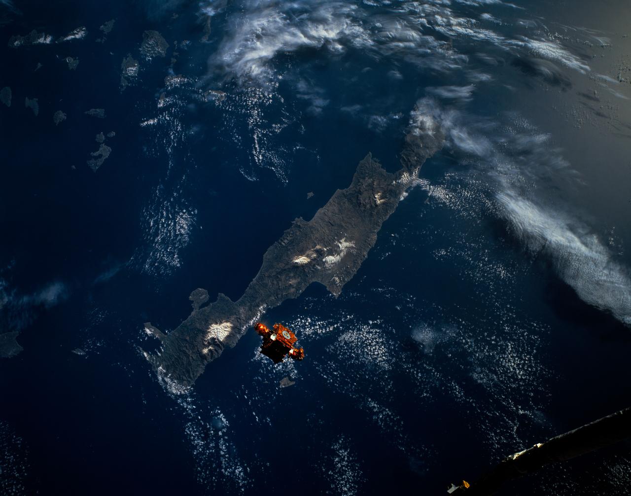 During STS-56, the Shuttle Pointed Autonomous Research Tool for Astronomy 201 (SPARTAN-201), a freeflying payload, was photographed by Discovery's, Orbiter Vehicle (OV) 103's, crewmembers as it drifted above the Mediterranean Sea near the island of Crete. On the mission's third day, the remote manipulator system (RMS) arm was used to lift SPARTAN-201 from its support structure in OV-103's payload bay and release it in space. SPARTAN-201 was later recaptured by OV-103's RMS and returned to Earth with the astronaut crew.