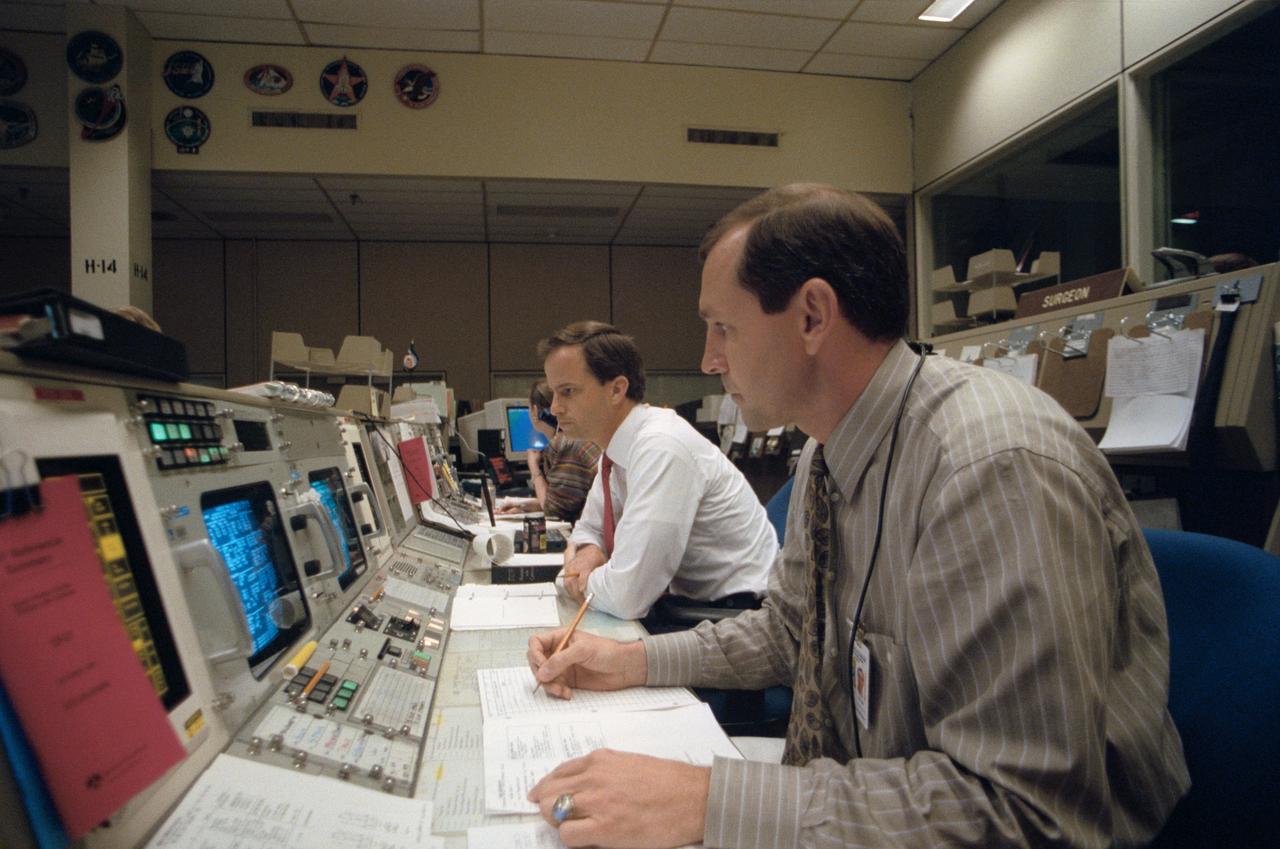 STS056-S-080 (13 April 1993) --- Astronauts Kevin P. Chilton (left) and Curtis L. Brown Jr. are seen at the spacecraft communicator (CAPCOM) console in the flight control room of Houston's Mission Control Center (MCC).  The two are part of the CAPCOM team who communicated with the five crewmembers aboard Discovery for the STS-56 mission in Earth orbit.