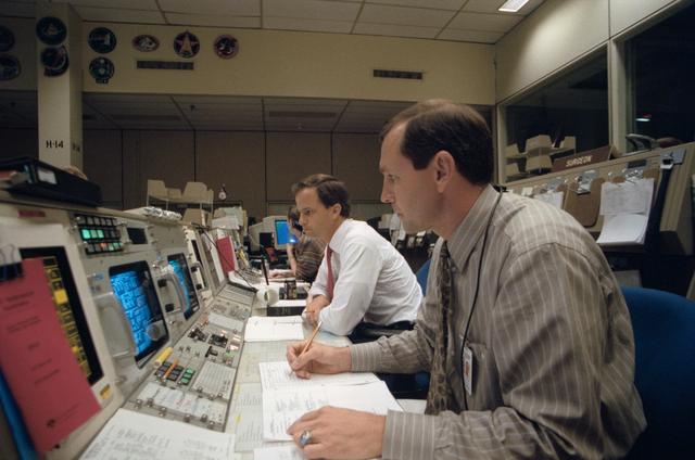 NASA image: STS-56 CAPCOMs Chilton and Brown monitor mission from a console at JSC MCC