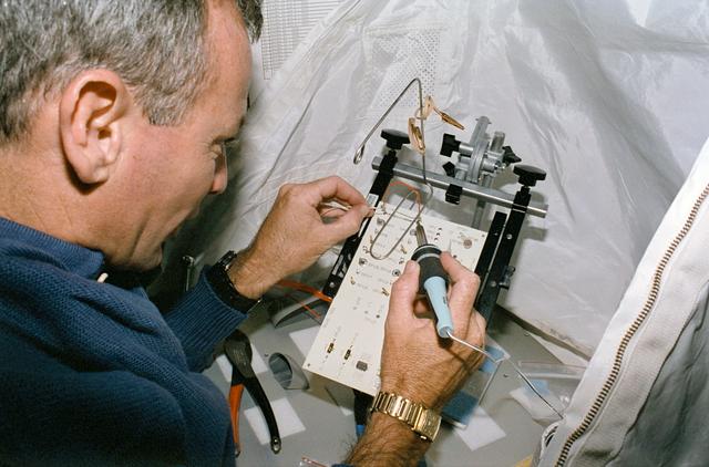 NASA image: STS-57 Pilot Duffy uses TDS soldering tool in SPACEHAB-01 aboard OV-105