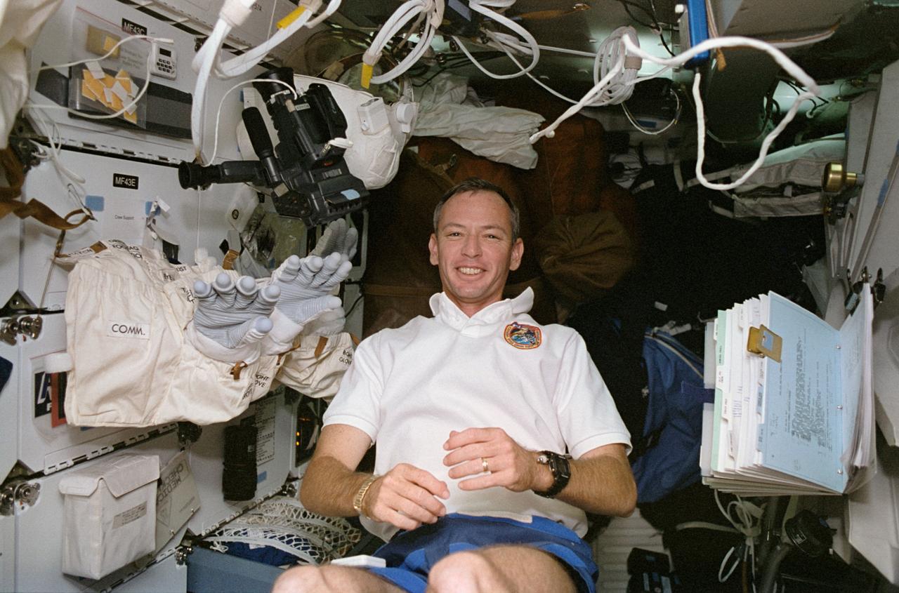 STS057-32-017 (24 June 1993) --- Near the airlock hatch on Endeavour's middeck, astronaut Brian Duffy, pilot, checks out some of the equipment to be used on the June 25 extravehicular activity (EVA) of two crewmates.  Less than 24 hours later, Duffy and three other NASA astronauts remained inside Endeavour's cabin while astronauts G. David Low and Peter J. K. (Jeff) Wisoff, began a lengthy, variegated session of EVA.