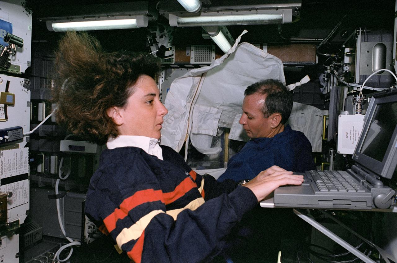 STS057-34-029 (21 June-1 July 1993) --- Astronaut Nancy J. Sherlock works on the Electronic Procedures Portion (EPROC) of the Human Factors Assessment (HFA) experiment.  Astronaut Brian Duffy works nearby.  The computer portion of HFA-EPROC simulated a space station propulsion system task.  Sherlock, Duffy and four other astronauts spent almost ten days aboard the Space Shuttle Endeavour for the STS-57 mission.