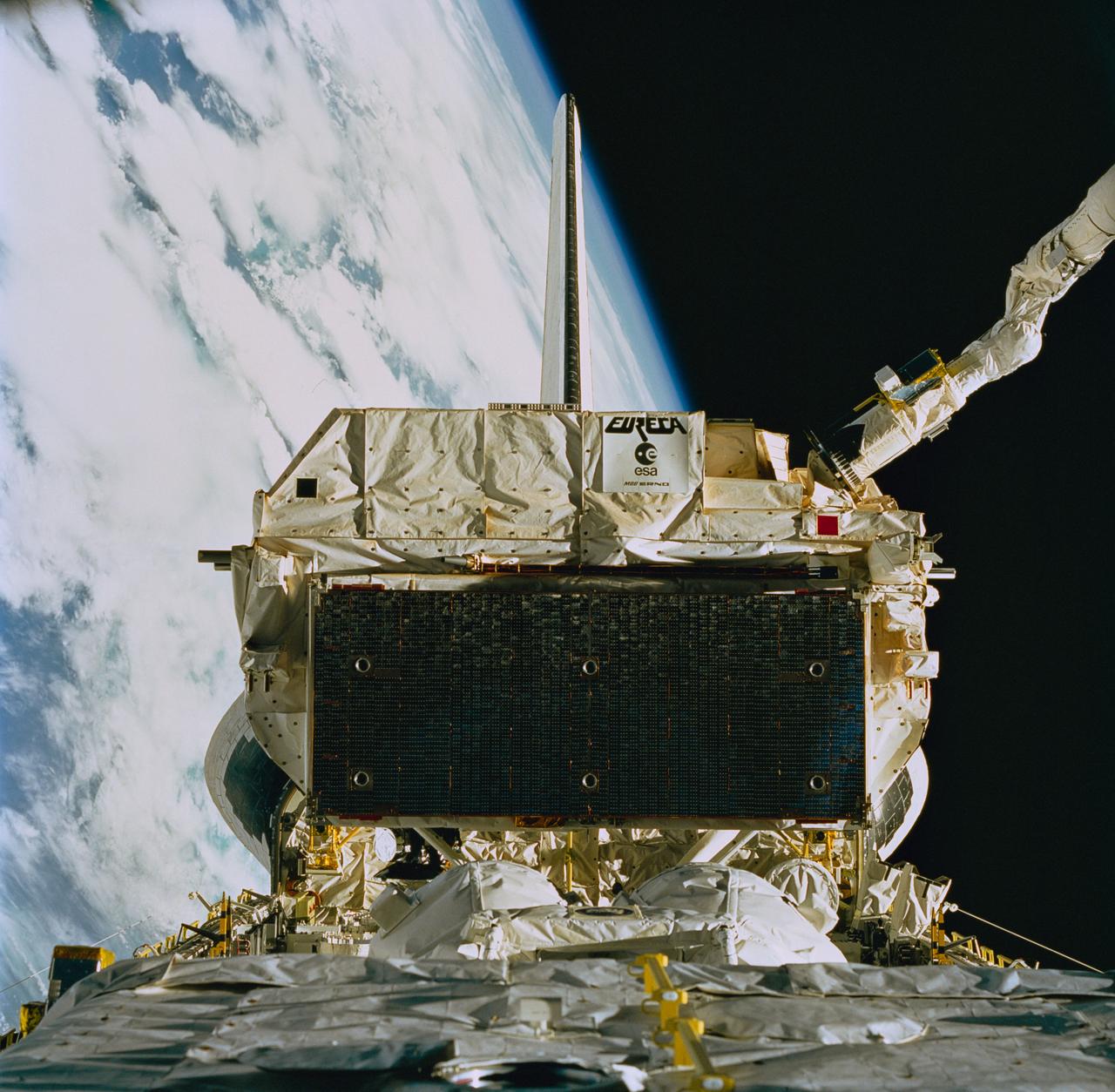 STS057-84-000AD (24 June 1993) --- The recently "captured" European Retrievable Carrier (EURECA) was recorded on 70mm film as it was berthed in the Space Shuttle Endeavour's aft cargo bay, assisted by the Canadian-built Remote Manipulator System (RMS), partially visible in upper right.  Moments later the RMS eased EURECA into its stowage area between Endeavour's aft cargo bay firewall and the SpaceHab module (partially visible in foreground).