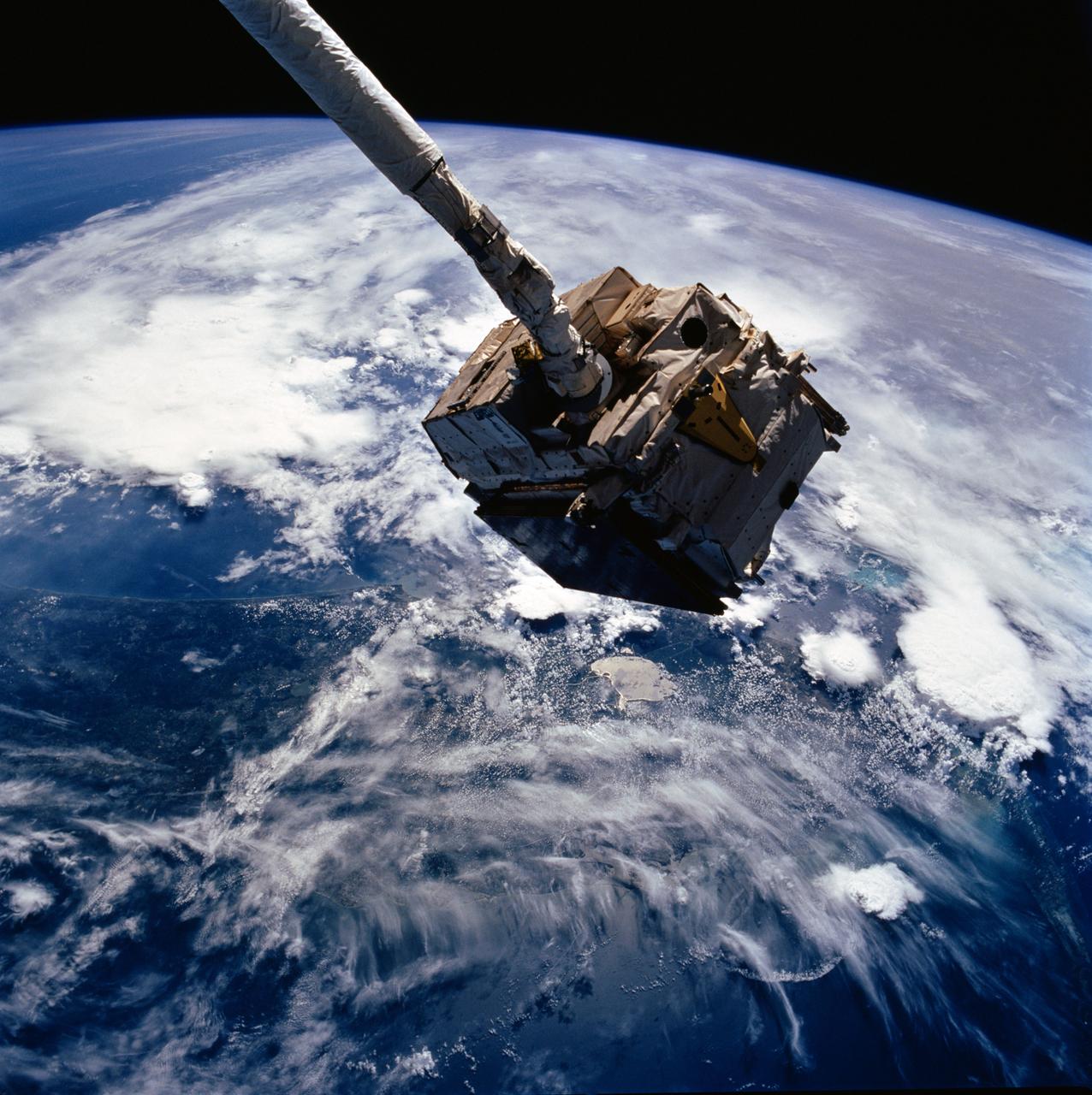 STS057-93-052 (24 June 1993) --- The European Retrievable Carrier (EURECA) is held in the grasp of the Space Shuttle Endeavour's Remote Manipulator System (RMS).  The photo was taken after EURECA's "capture" from Earth-orbit but prior to its berthing in the Shuttle's cargo bay.  The southern two-thirds of the state of Florida, part of the Gulf of Mexico and clouds over the Atlantic form the backdrop for the 70mm image.