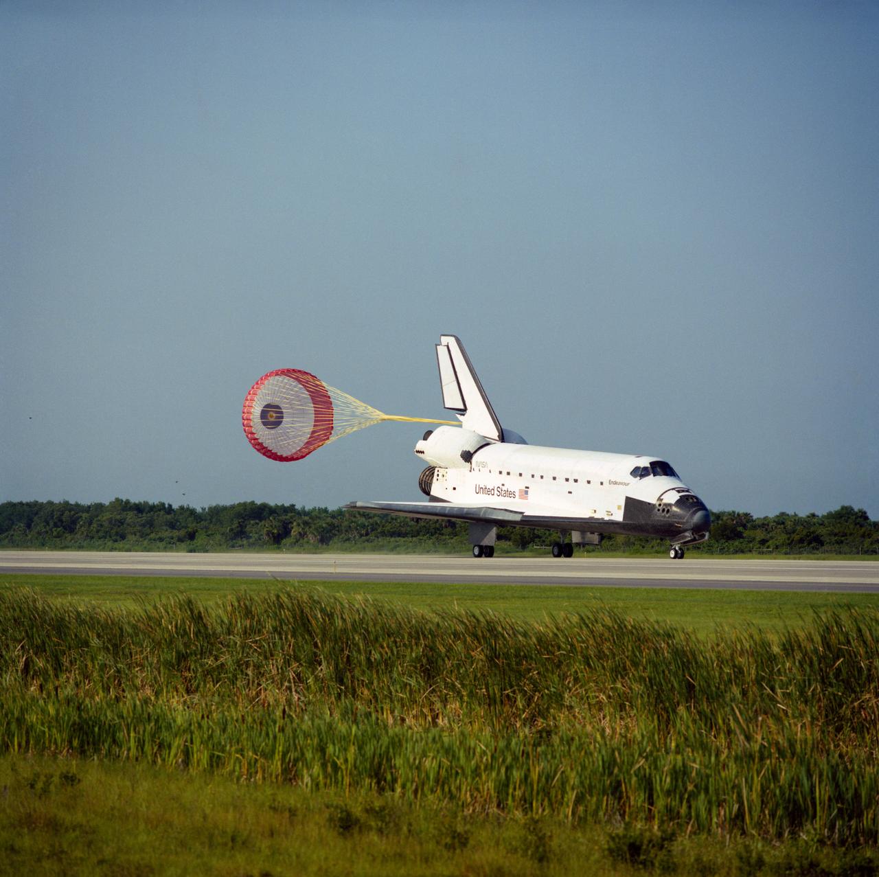 STS057-S-082 (1 July 1993) --- The drag chute on the Space Shuttle Endeavour is fully deployed in this scene on Runway 33 (KSC's Shuttle Landing Facility) as the spacecraft successfully completes a ten-day mission in Earth orbit.  Official mission duration was nine days, twenty-three hours, forty-four minutes and fifty-five seconds.  Main gear touchdown occurred at 8:52:16 (EDT), July 1, 1993.  Onboard Endeavour for the landing were six NASA astronauts and the European Retrievable Carrier (EURECA) spacecraft.  Crewmembers were astronauts Ronald J. Grabe, Brian Duffy, G. David Low, Nancy J. Sherlock, Peter J. K. (Jeff) Wisoff and Janice E. Voss.