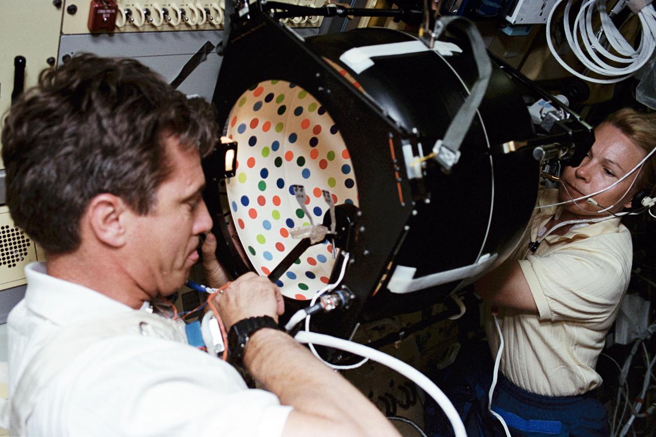 STS058-03-020 (18 Oct.-1 Nov. 1993) --- In the Spacelab onboard the space shuttle Columbia, STS-58 Commander John Blaha is positioned at the Rotating Dome vestibular experiment as Payload Commander Rhea Seddon sets up the experiment. Photo credit: NASA